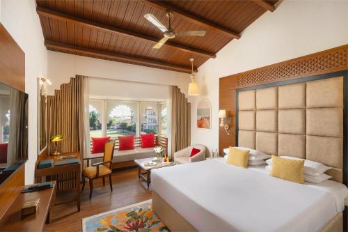 a bedroom with a large bed and a living room at Gateway Kandla Gandhidham in Gandhidham