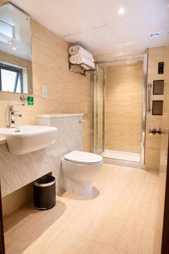 a bathroom with a toilet and a sink and a shower at Eurotraveller Hotel- Express (Elephant & Castle) in London
