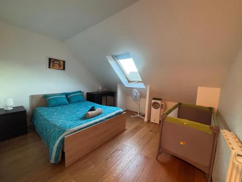 a bedroom with a bed with a teddy bear on it at La maison penchée in Rosny-sous-Bois