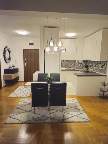 a kitchen and living room with a table and chairs at Zozo's Apartment in Sarajevo