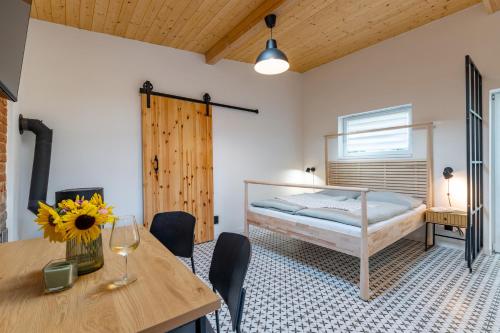 a bedroom with a bed and a table and chairs at gardenSTUDIO in Děčín