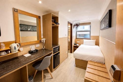a hotel room with a bed and a desk at Eurotraveller Hotel- Express (Elephant & Castle) in London
