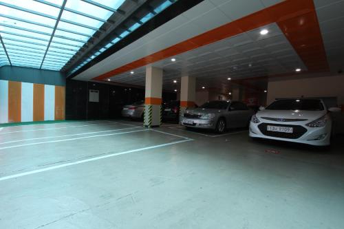 a parking garage with two cars parked in it at Show Hotel in Pyeongtaek