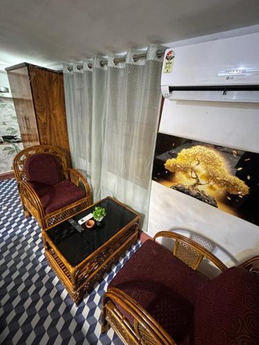 a living room with a chair and a table at Luna leaf Homestay in Guwahati