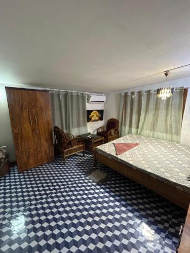 a bedroom with a bed and a table and chairs at Luna leaf Homestay in Guwahati