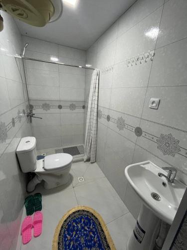 a bathroom with a toilet and a sink at Musobek Guest House in Khiva