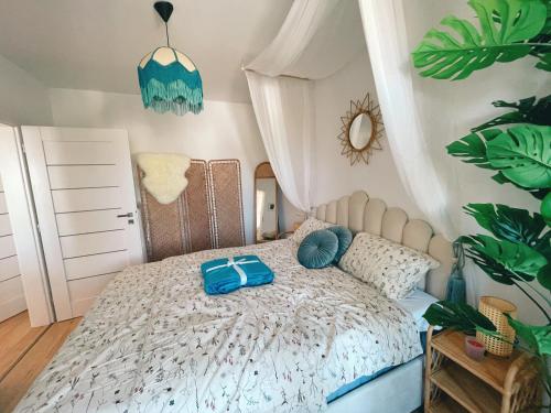 a bedroom with a bed with a blue bag on it at Angel's Home in Dunajská Streda