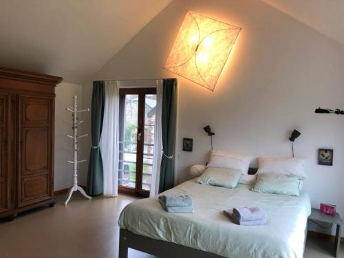 a bedroom with a bed with two towels on it at Au Grand Babin - Namur in Namur