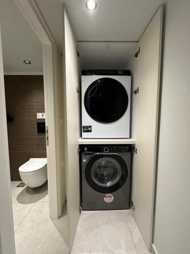 a bathroom with a washing machine and a toilet at Modern Lofts in Archangelos Rhodes with Parking - Equus - 3 Guests in Archangelos