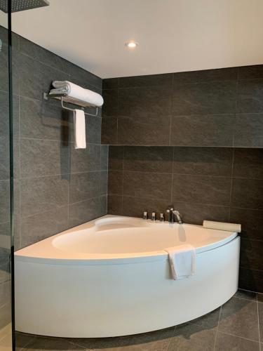 a bath tub in a bathroom with a shower at Westlake view Duplex Studio in Hanoi
