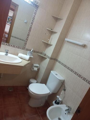 a bathroom with a toilet and a sink at Altura Sunshine in Altura