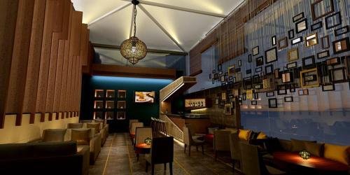 a restaurant with chairs and tables and a chandelier at Pearltree Hotels And Resorts in Purulia