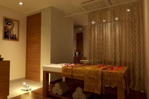 a bathroom with a table with red roses on it at Pearltree Hotels And Resorts in Purulia