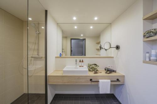 a bathroom with a sink and a mirror at Black F House - Serviced Apartments in Freiburg im Breisgau