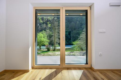 an empty room with a sliding glass door at Cirus Riverfront Kolpa & Rafting in Kočevje