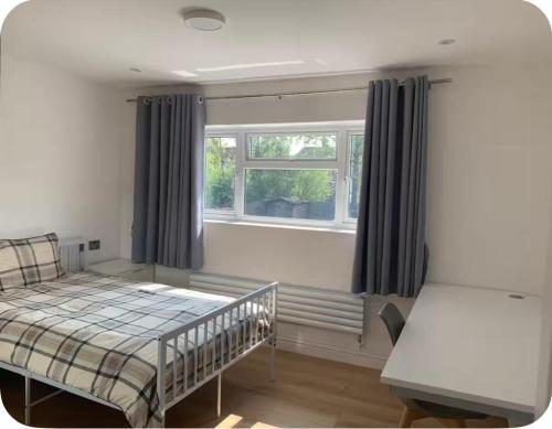 a bedroom with a bed in front of a window at Bushy Hill Drive in Guildford in Guildford