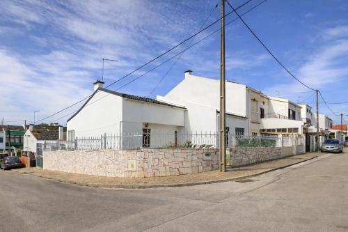 a white house on the side of a street at Private Room in Corroios 15 Minutes from the Beach - Quarto Privado em Corroios com Fácil Acesso à Praia e Lisboa in Corroios