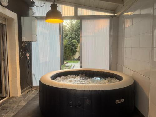 a large bath tub in a room with a window at Casa Negra in Moralzarzal