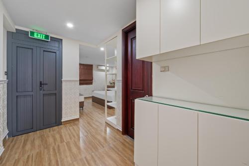 a room with a door with a sign that reads exit at AVA Hotel & Apartment in Danang