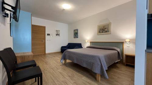 a bedroom with a bed and a chair at Residenza Montegrappa in Peschici