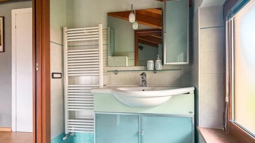 a bathroom with a sink and a mirror at Alloggi Nell's in Cornedo Vicentino
