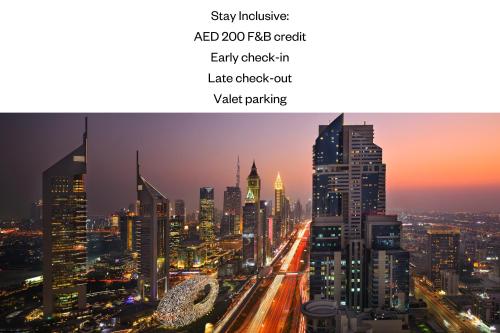 a view of a city skyline at night at voco Dubai by IHG in Dubai