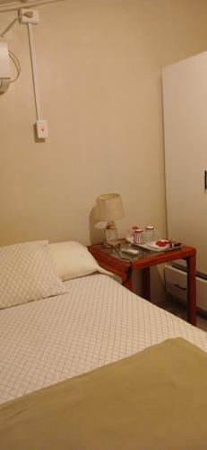 a bedroom with two beds and a desk with a lamp at Maria's Sanctuary in San Juan
