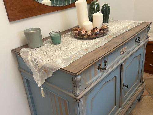 a table with candles on top of a blue cabinet at Rhome country lodge in La Massimina-Casal Lumbroso