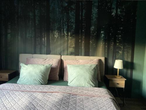 a bedroom with a bed with trees on the wall at Voll ausgestattete, helle Ferienwohnung auf 80 qm in Wutöschingen