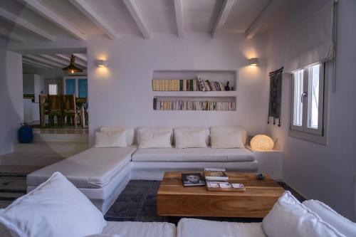 a living room with a couch and a coffee table at Villa Moon with Private Swimming Pool in Aspro Chorio Paros