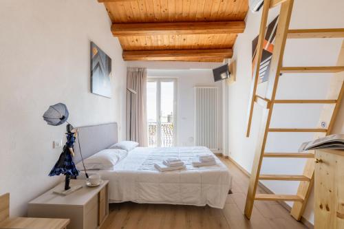 a bedroom with a bed and a ladder at Aghèl Luxury Room in Recanati