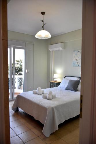 a bedroom with a bed with two towels on it at Seaside apartment platana kimis evoia in Kymi