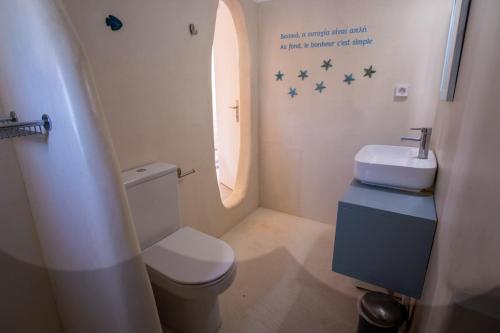 a bathroom with a toilet and a sink and stars on the wall at Villa Moon with Private Swimming Pool in Aspro Chorio Paros