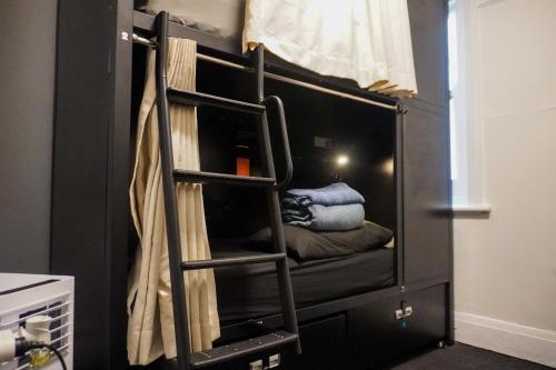 a bunk bed with a ladder in a room at Tequila Sunrise Potts Point in Sydney