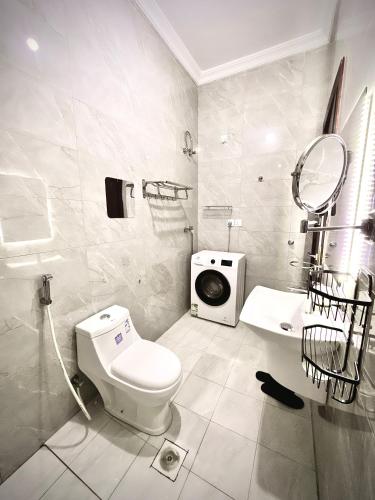a white bathroom with a toilet and a sink at شقة vip غرفتين نوم in Jeddah