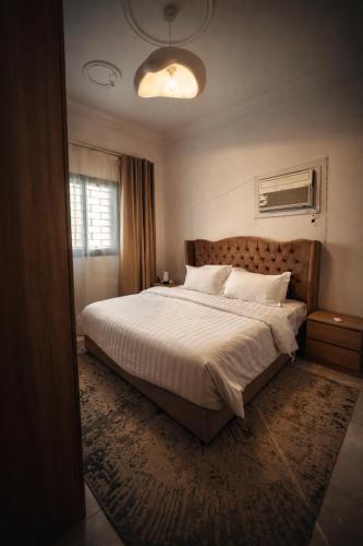 a bedroom with a large bed and a window at شقة vip غرفتين نوم in Jeddah