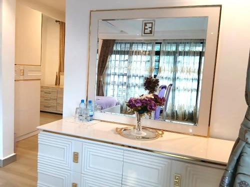 a vase of flowers on a counter with a mirror at Silva Montana in Mount Kenya