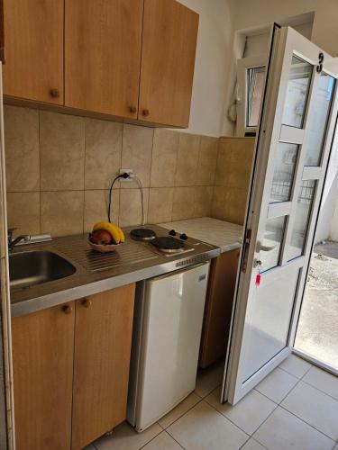 a kitchen with a sink and a banana on the counter at Apartmani Vista Čanj in Čanj