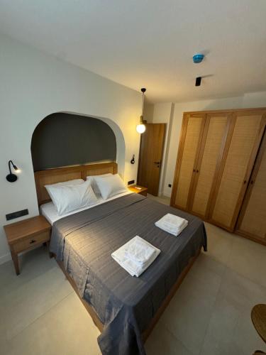 a bedroom with a large bed with two towels on it at Ultava Koru Suites in Datca