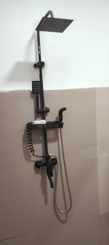 a hair dryer hanging on a wall at Safe Haven Residence in Talibon