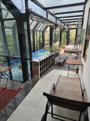 a patio with a pool and a bench and a swimming pool at Lexe Palace Tam Dao in Tam Ðảo