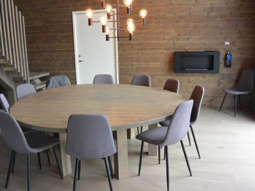 a conference room with a wooden table and chairs at 12 person holiday home in IDRE in Idre