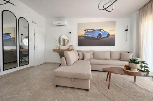 a living room with a couch and a car on the wall at Aura Residence Beachfront by Horizon Homes in Ofrínion