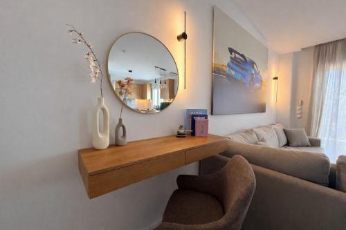 a living room with a mirror and a couch at Aura Residence Beachfront by Horizon Homes in Ofrínion