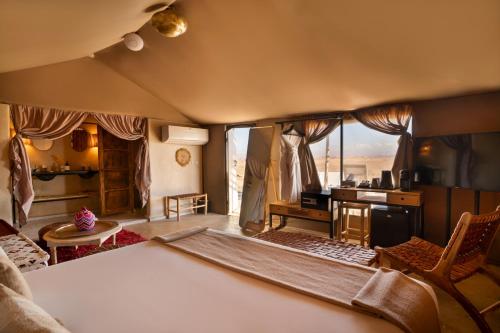 a living room with a view of a kitchen and a room at Mia Agafay Resort in El Karia
