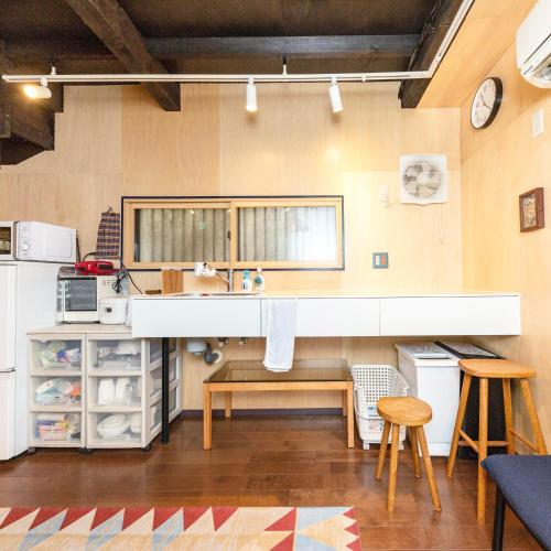 a kitchen with a sink and a counter at May Guest House in Tokyo