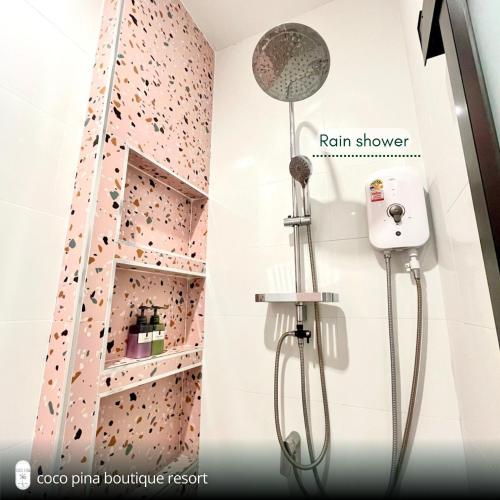 a bathroom with a rock climbing wall at Coco Pina in Prachuap Khiri Khan