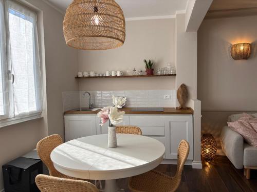 a kitchen and dining room with a white table and chairs at HH Moneglia La Caletta in Moneglia