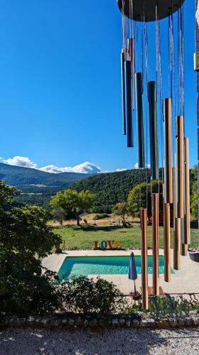 a swimming pool with a bunch of chandeliers at Les Sources chambres dhotes in Bargème