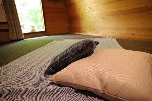 a pillow sitting on a bed in a room at Camping Pod's in Hanworth